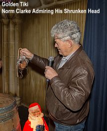 Golden Tiki Norm Clarke admiring his shrunken head